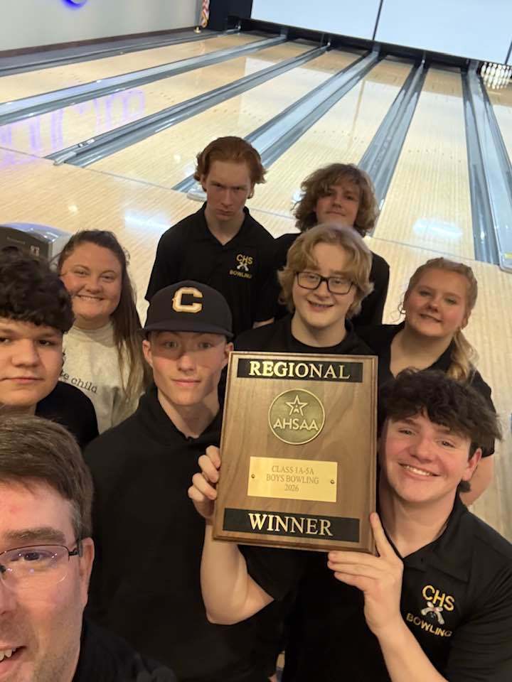 Corner High School's bowling team poses with their regional trophy at the bowling alley.