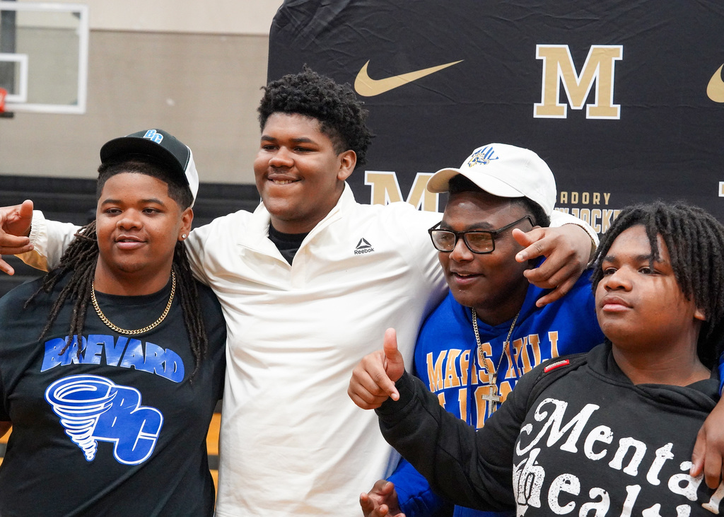 A group of student-athletes pose for a picture during National Signing Day at McAdory High School. 
