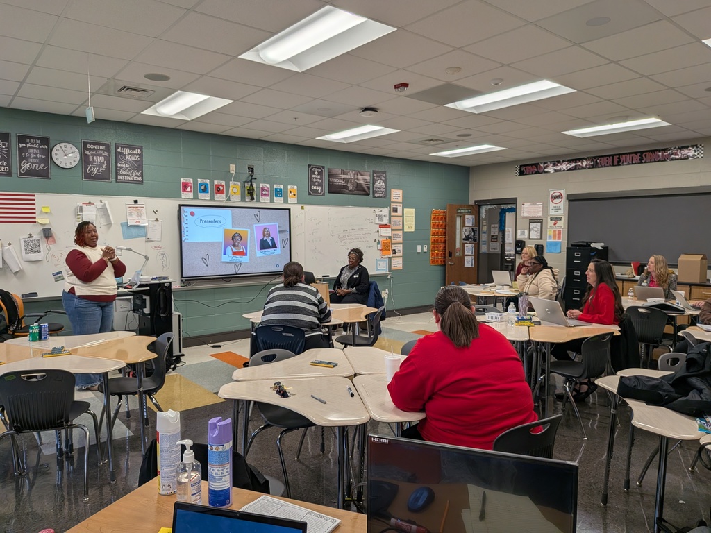 Ms. Delfreda Coleman leads a presentation inside a classroom.