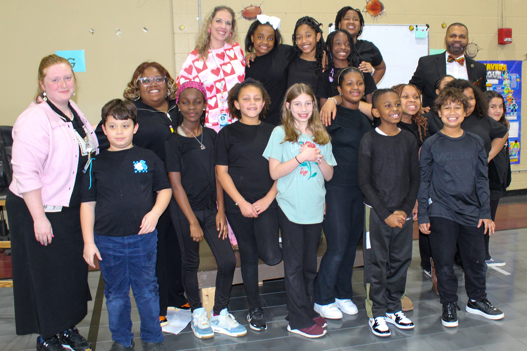 Johnson Elementary School students, teachers and principal stand together for a photo in the school gym. The students pictured were getting ready to perform in the school's Black History Month play. 