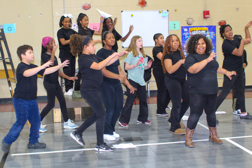 Johnson Elementary students perform a dance inside the school gym.
