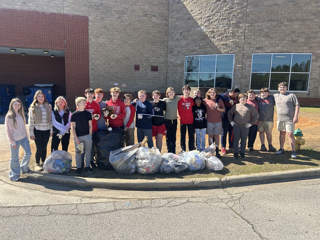 Group of Middle School TSA students with bags of trash they picked up