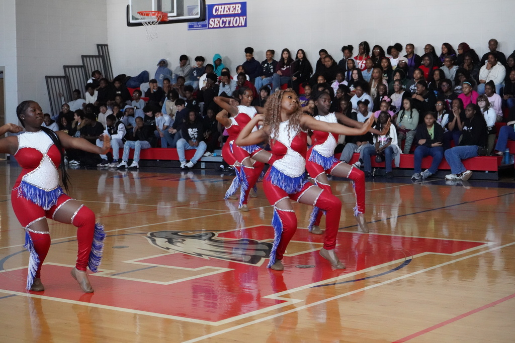 Erwin Middle School's dance team performs a routine in front of students in the school gym.