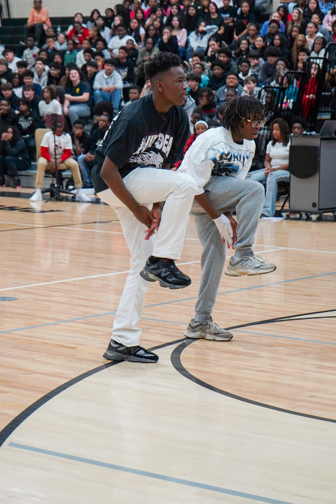 Students perform a routine during McAdory Middle School's Black History Month program. They perform in the middle of the school gym.