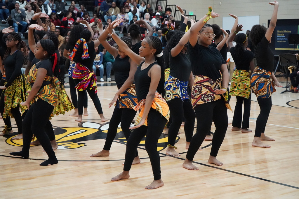 McAdory Middle School's dance team performs a routine during the school's Black History Month program. They dance in the middle of the school gym.