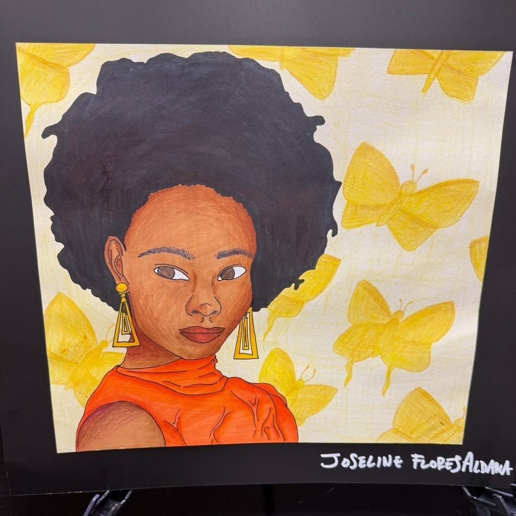 A picture of a work of student art. The artwork depicts an African American woman in an orange dress in front of a background of yellow butterflies.