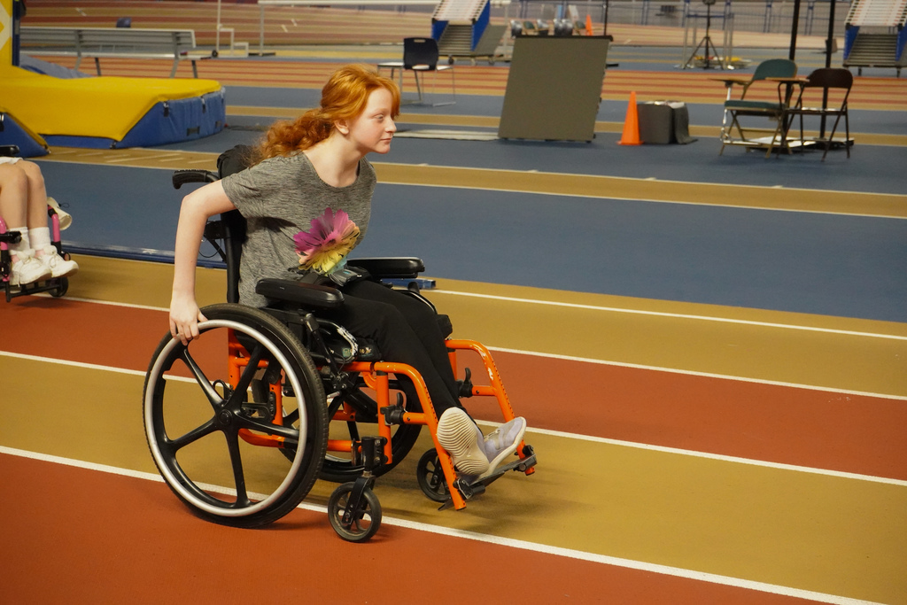 A student using a wheelchair races down the track at the Birmingham CrossPlex.