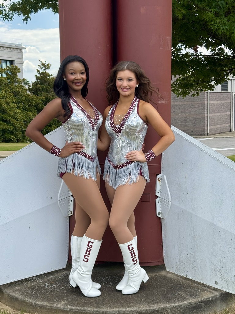 Harmony Shepherd and Brooklyn Cheek stand together for a photo. They're wearing Gardendale High School Rockette uniforms and are standing outside the school.