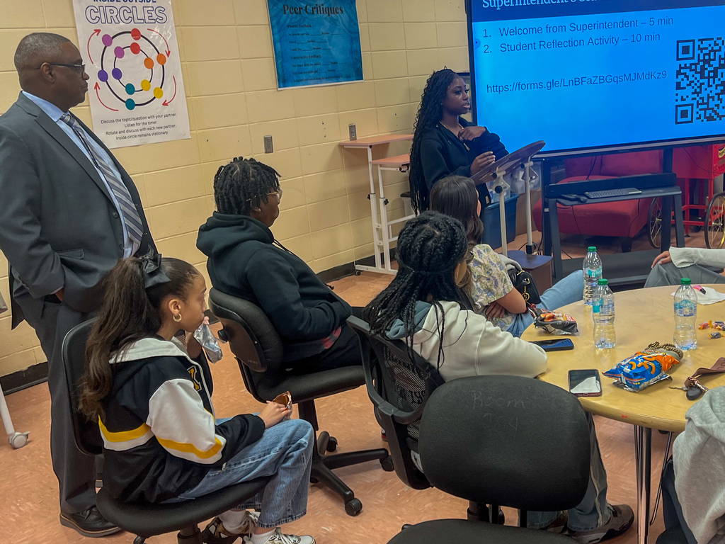 A student stands at the front of a room and addresses fellow students and JEFCOED Superintendent Dr. Gonsoulin during the Superintendent's Student Advisory Council meeting.