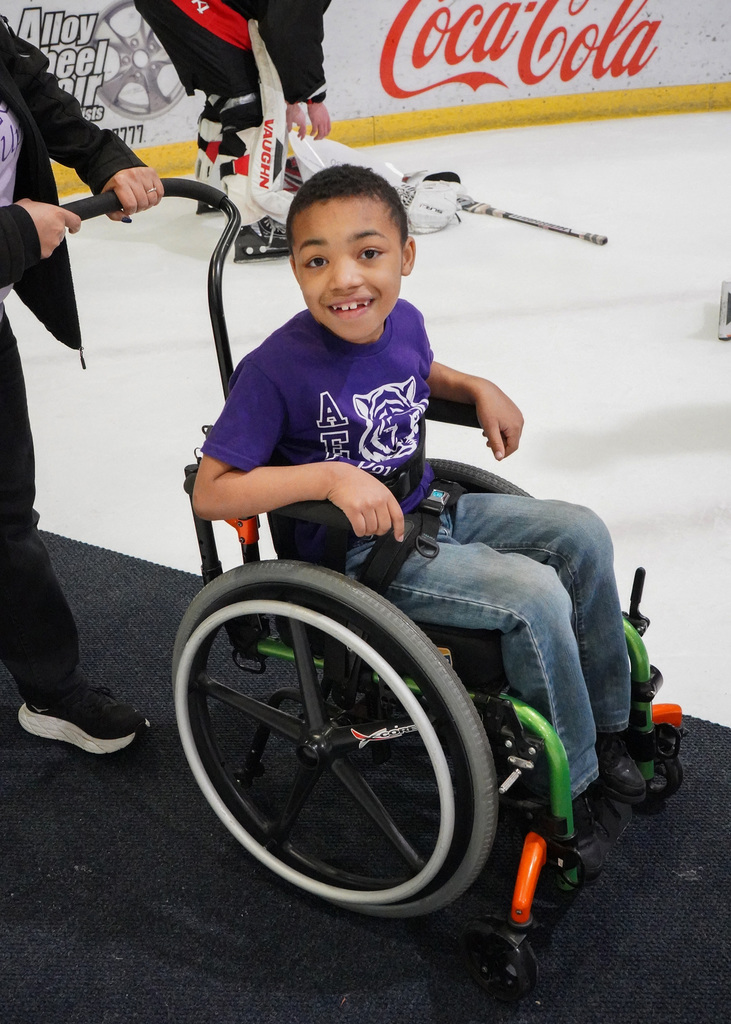 An Adamsville Elementary School student is being wheeled out onto the ice to meet the Birmingham Bulls.