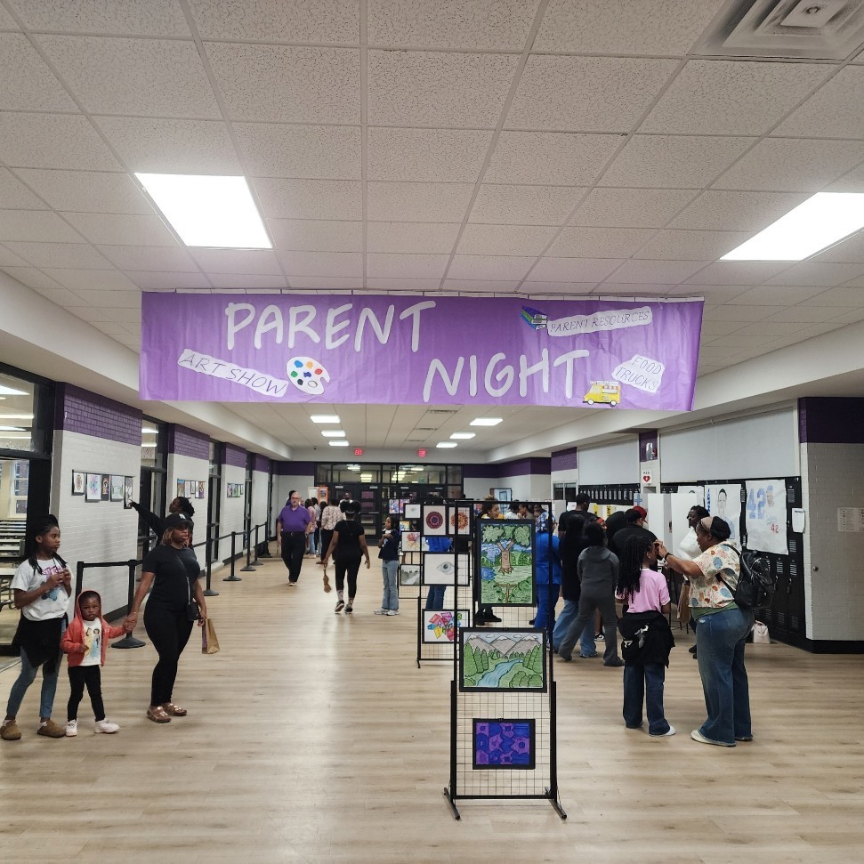 Minor Middle families visiting with teachers and enjoying student art Minor Middle's Parent Night.