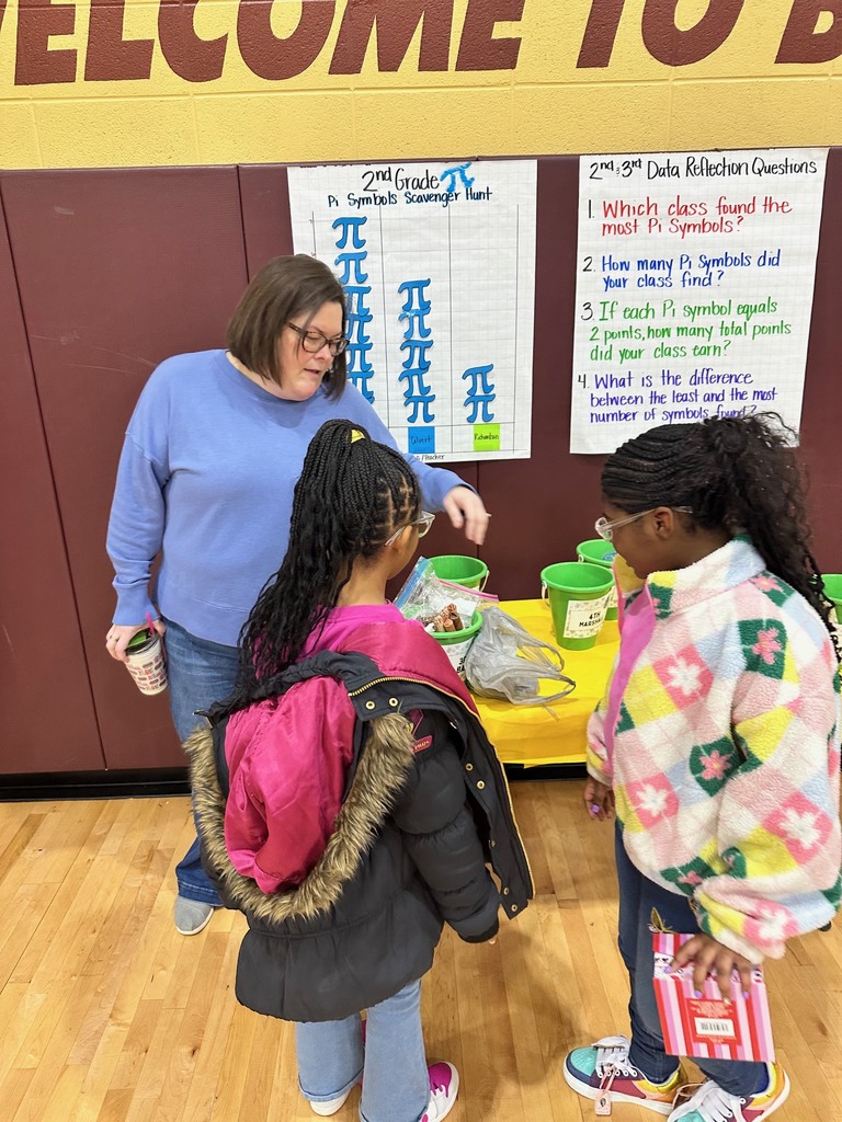 a teacher and students putting coins into a green bucket that will go towards raising fund for peer helpers