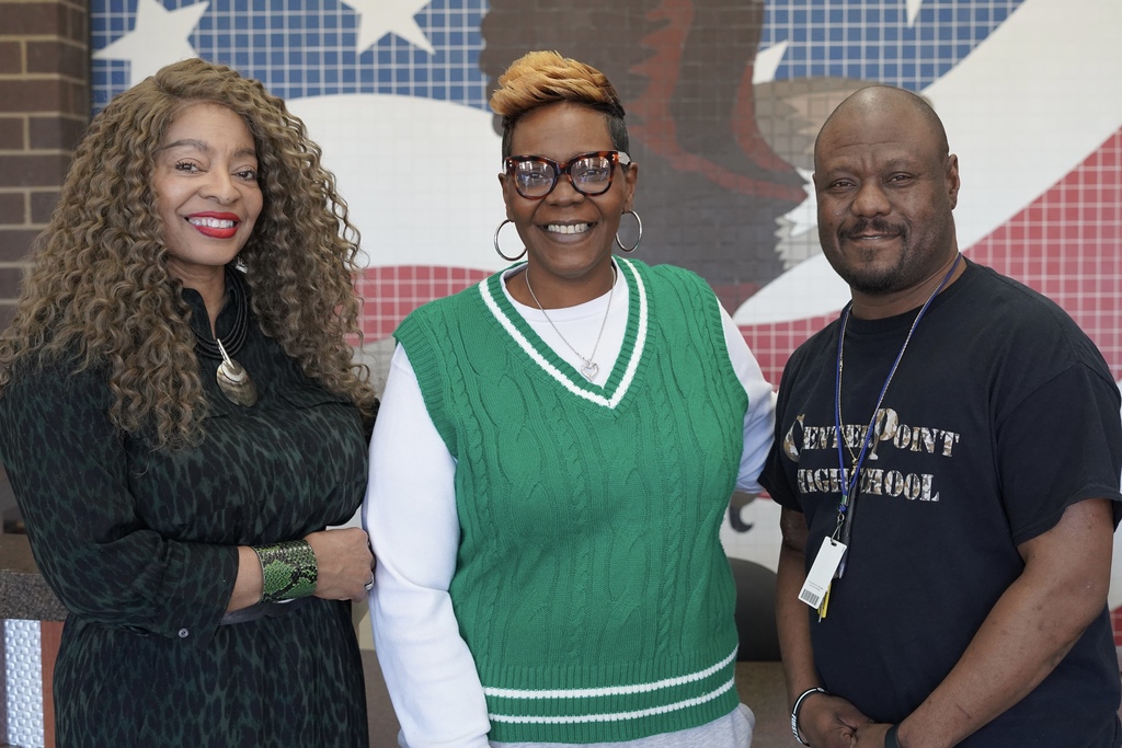 Center Point Assistant Principal Ms. Reid stands with teachers Ms. Anderson and Mr. Pope for a photo. They stand in front of an eagle background.