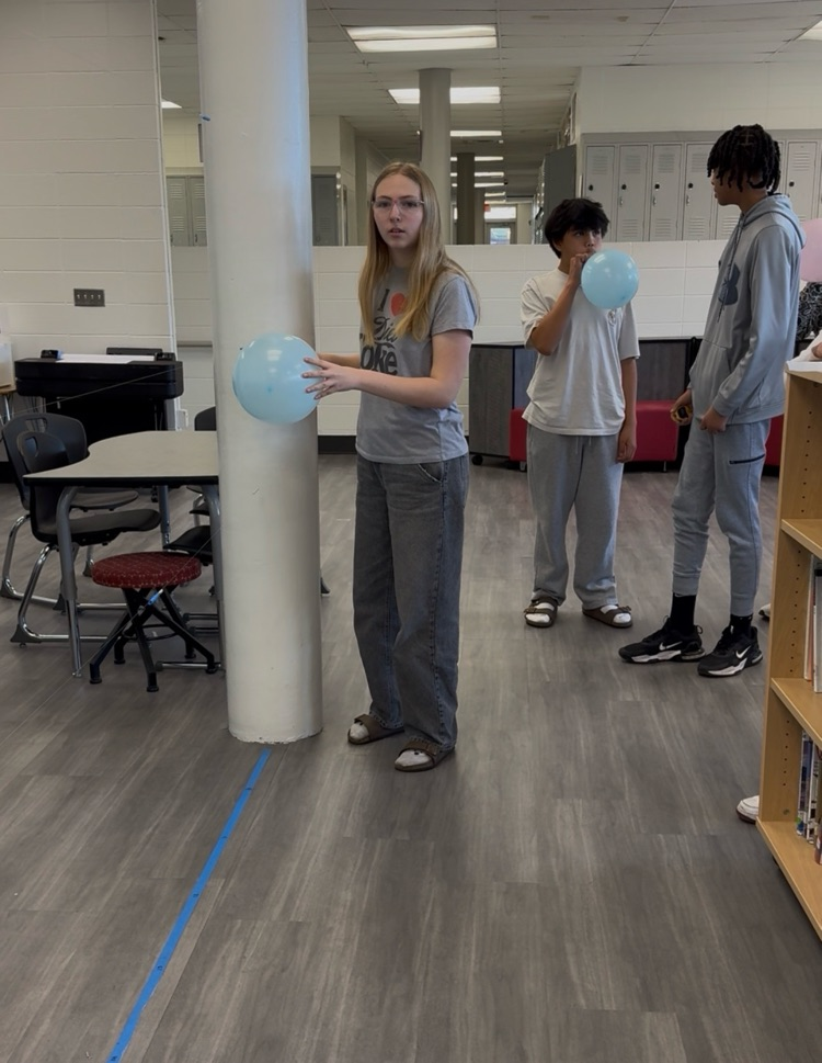 student sending balloon rocket