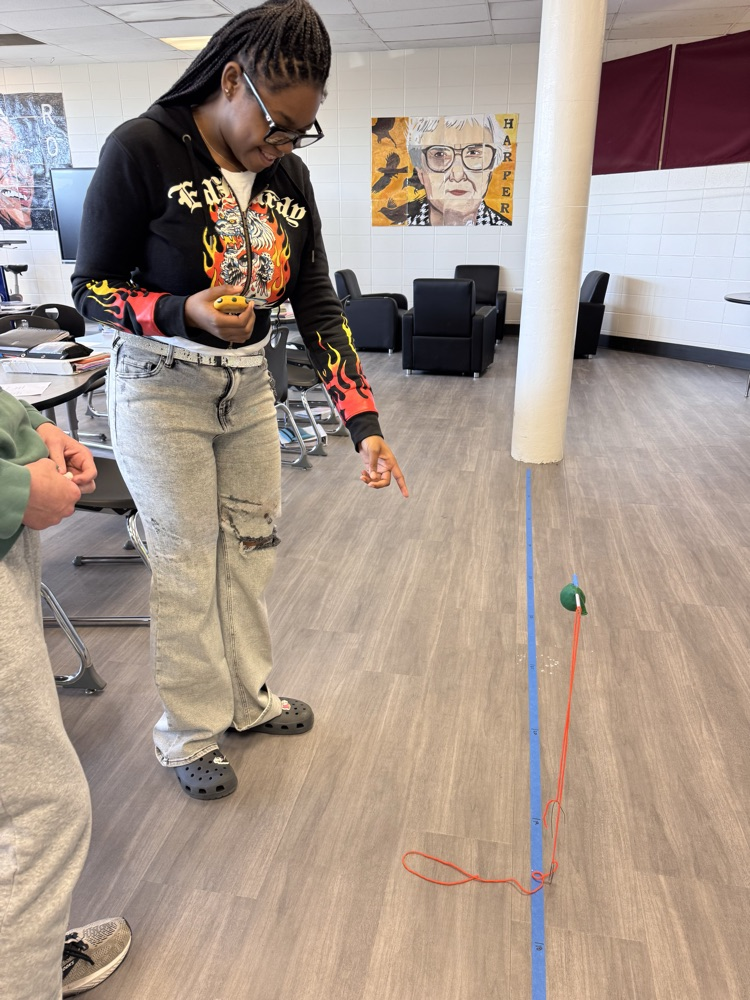 student looking at the time it took a balloon rocket to travel 