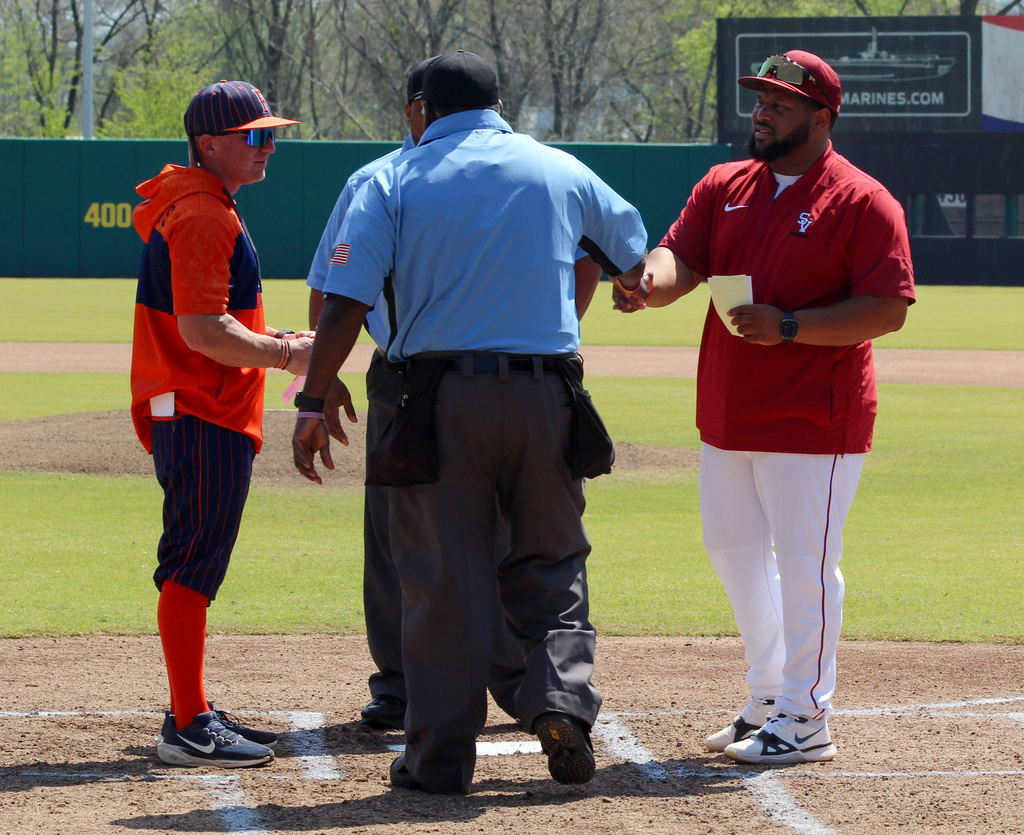 Coaches from the Fultondale High School and the Shades Valley High School baseball teams meet with the umpires on the pitchers mound during the 4th Annual Rickwood Classic at Historic Rickwood Field in Birmingham, AL.