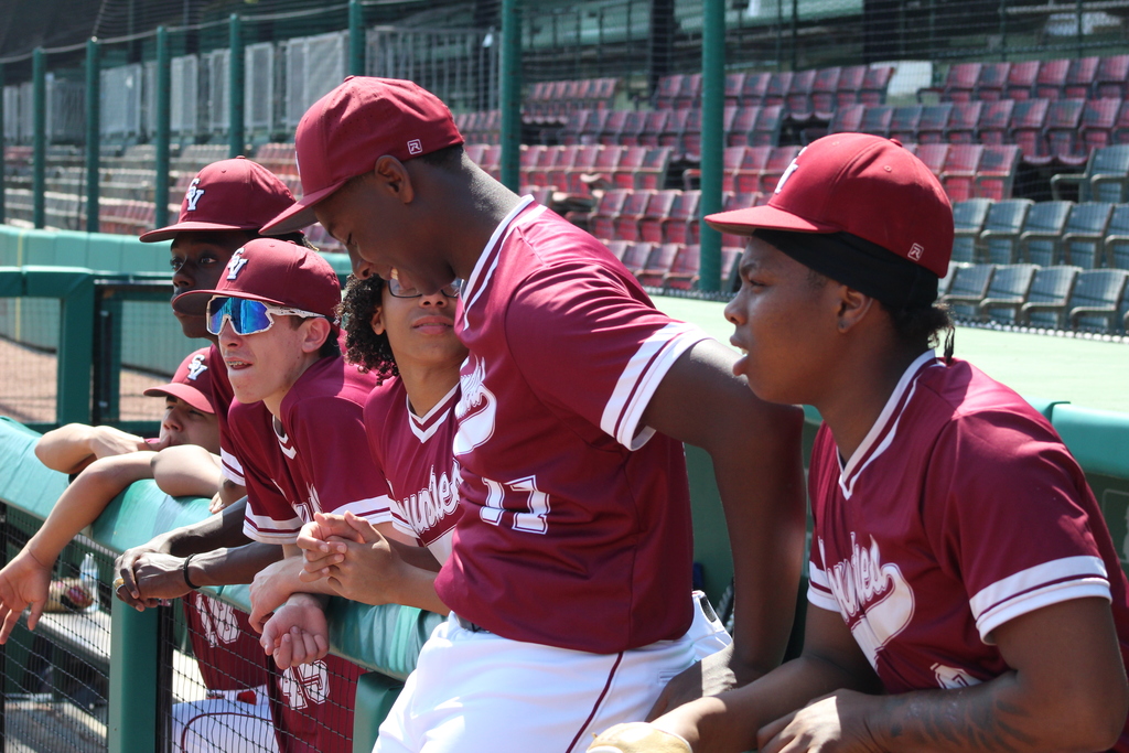 Shades Valley High School Baseball players sit along the fence and talk during the 4th Annual Rickwood Classic at Historic Rickwood Field in Birmingham, AL.