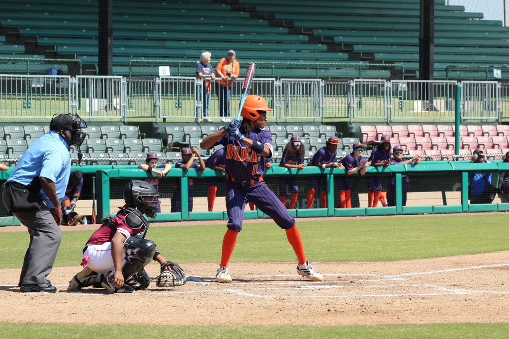 A Fultondale High School baseball player stands at home plate ready to take a swing, while the catcher and umpire look on. They are participating in the 4th Annual Rickwood Classic at Historic Rickwood Field in Birmingham, AL.