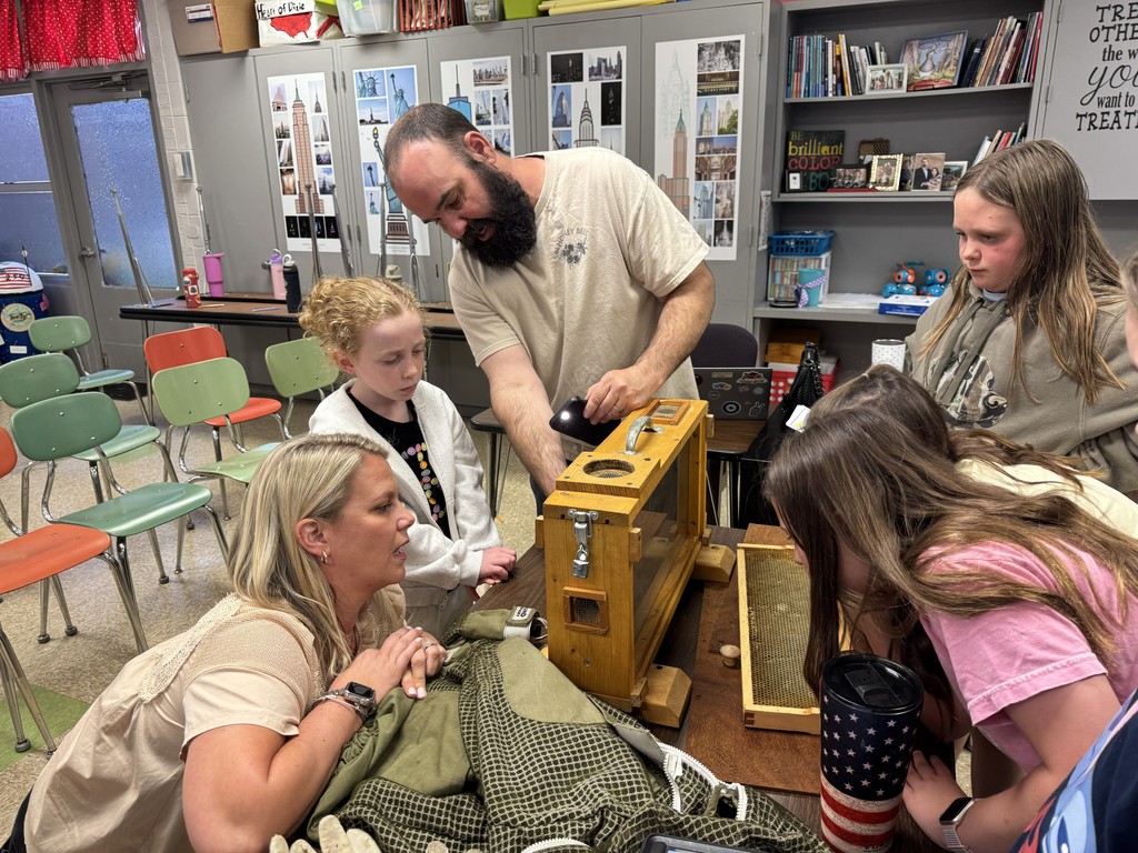 4th grade RLC students and Mrs. Wakefield are getting an up close look at an observation hive with a visiting beekeeper.