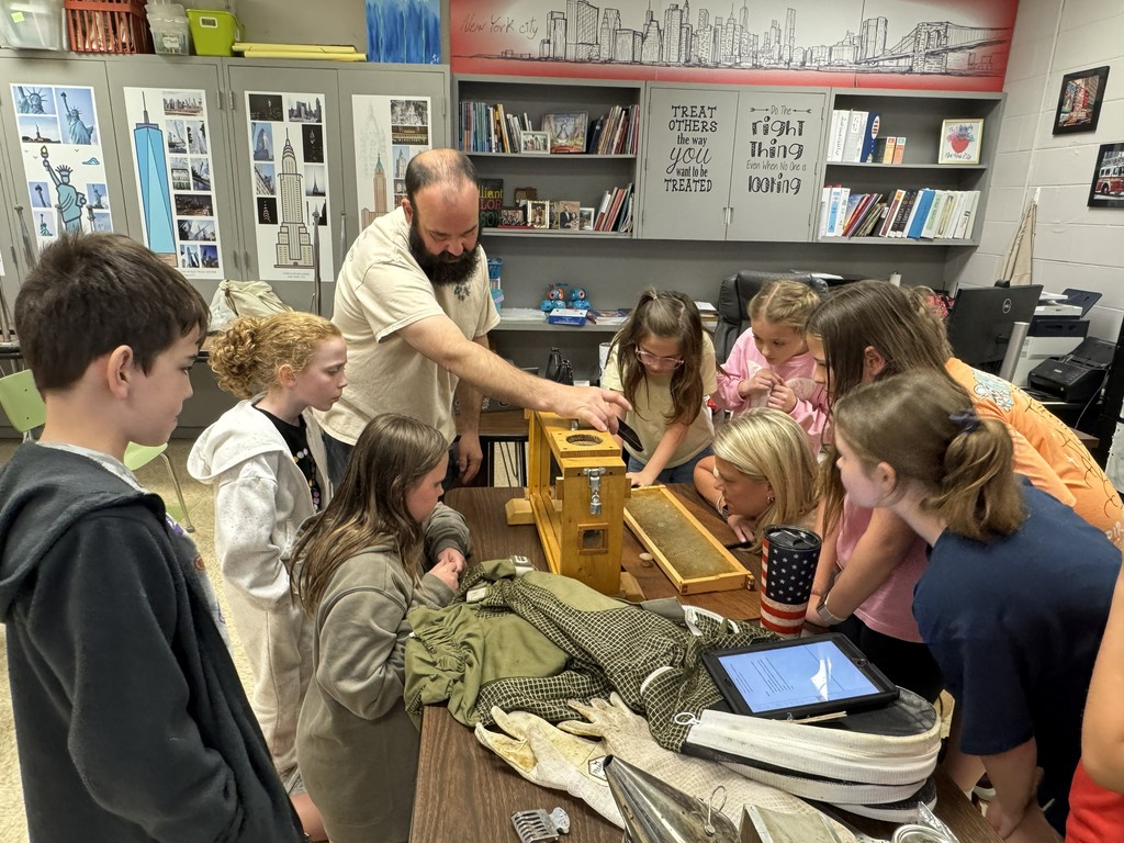 4th grade RLC students and Mrs. Wakefield are getting an up close look at an observation hive with a visiting beekeeper.