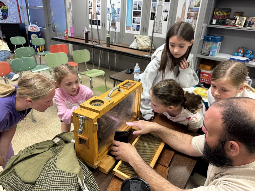 4th grade RLC students are getting an up close look at an observation hive with a visiting beekeeper.