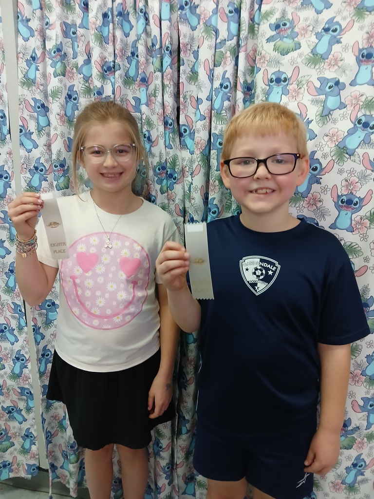 students displaying ribbons won at Science olympiad competition