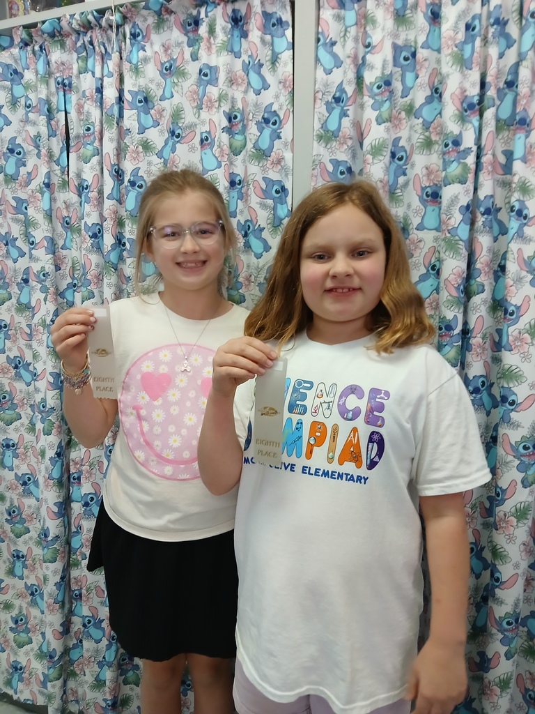 students displaying ribbons won at Science olympiad competition