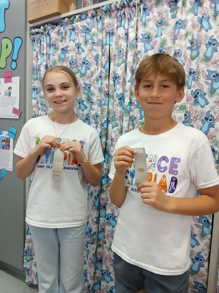 students displaying ribbons won at Science olympiad competition