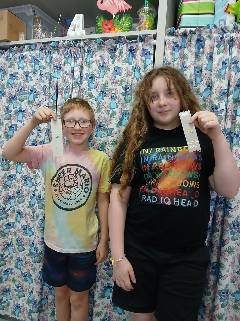 students displaying ribbons won at Science olympiad competition