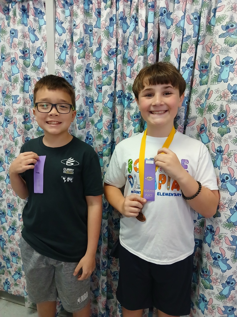 students displaying ribbons won at Science olympiad competition