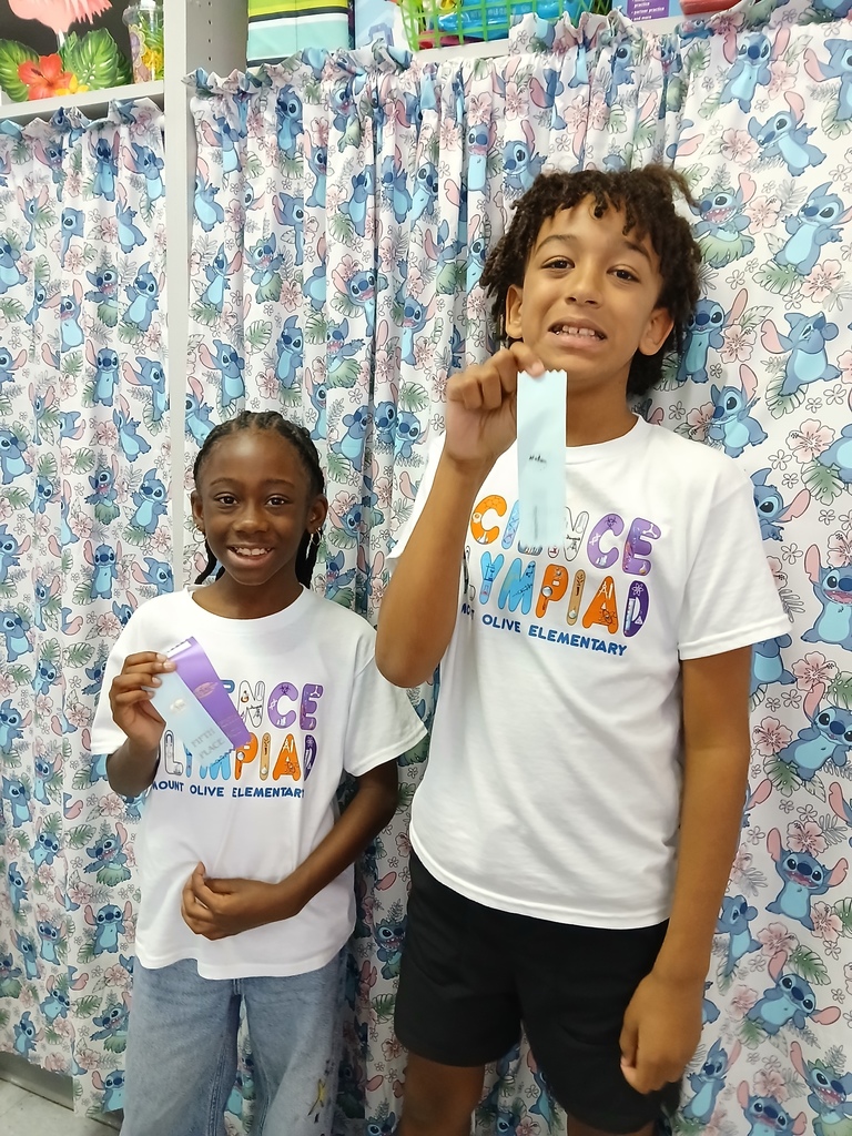 students displaying ribbons won at Science olympiad competition