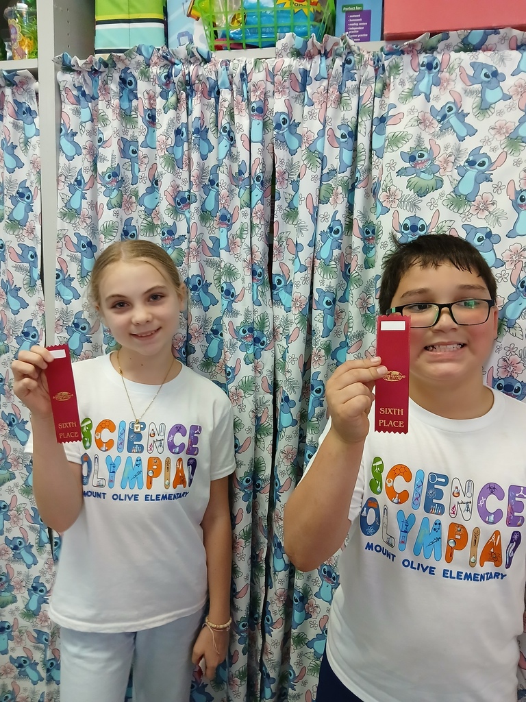 students displaying ribbons won at Science olympiad competition