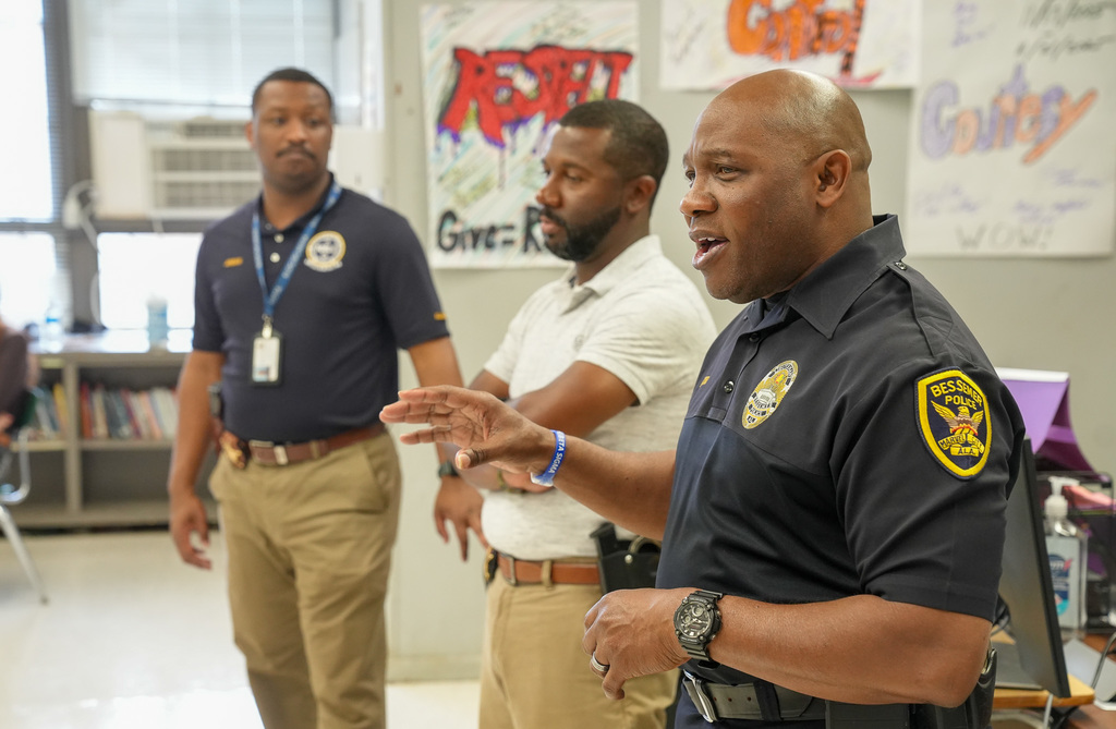 Bessemer Police Officers stand in a classroom and speak.