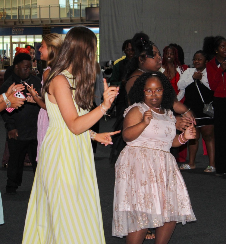 Two girls wear formal dresses and dance at JEFCOED’s Exceptional Prom.