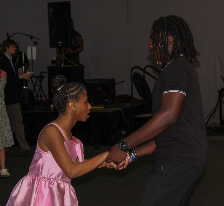 A boy and a girl hold hands and dance at JEFCOED’s Exceptional Prom.