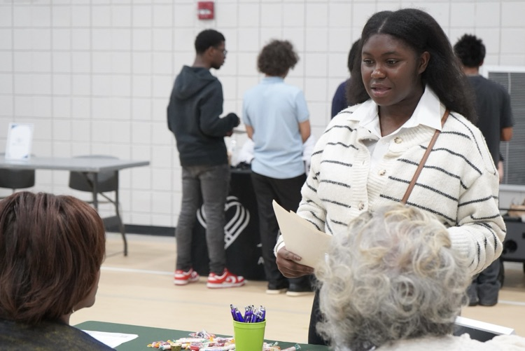 A JEFCOED student speaks with representatives from a company during the JEFCOED Industry Connection Day.