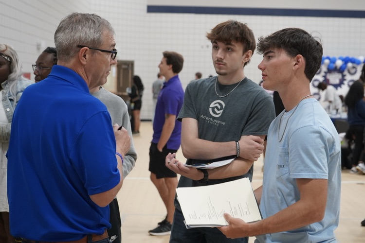 Two JEFCOED students speak to a representative of a company inside the Gardendale Civic Center during the JEFCOED Industry Connection Day