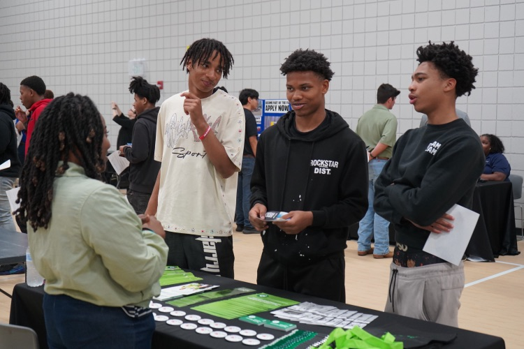 A group of JEFCOED Students speak to a representative of a company during the JEFCOED Industry Connection Day at the Gardendale Civic Center.