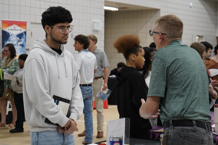 to a Jefcoed student during the Industry Connection Day at the Gardendale Civic Center.