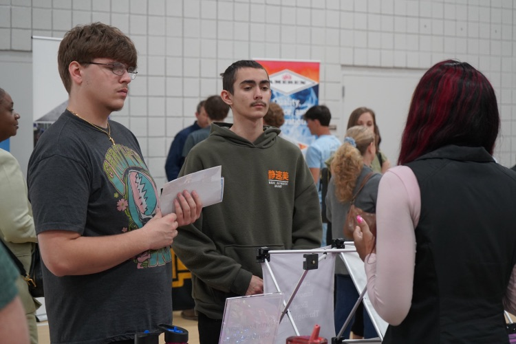 A group of students listen to a representative of a company during the JEFCOED Industry Connection Day.