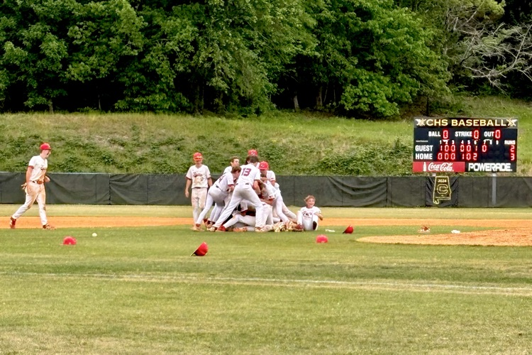 Oak Grove Middle School baseball players tackle each other after winning the JEFCOED Tournament  