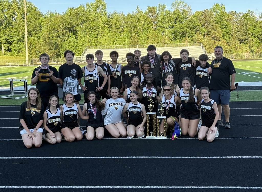 Corner Middle School track and field members pose for a photo with first and second place trophies from the JEFCOED Track and Field Championship.