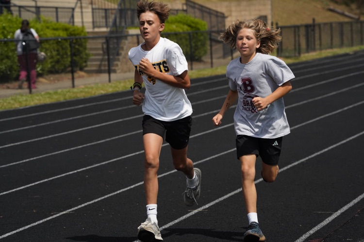 Students from Corner Middle School and Bragg Middle School run down the track at the 6th Grade Track and Field Championship.