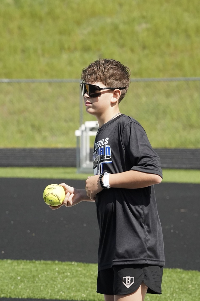 A student holds a softball while competing at the JEFCOED 6th Grade Track and Field Championship.