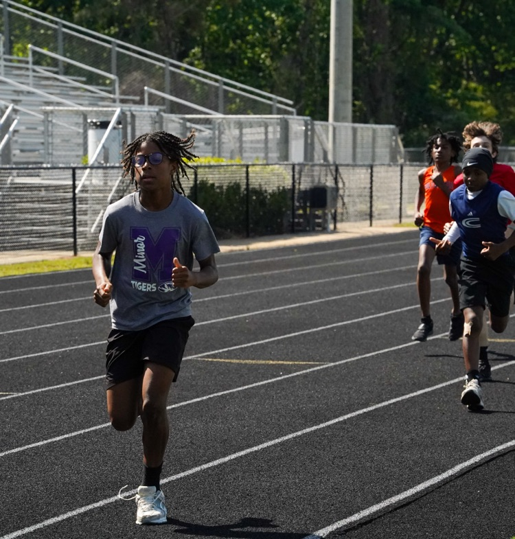 Students run down the track at the 6th grade Track and Field Championship.