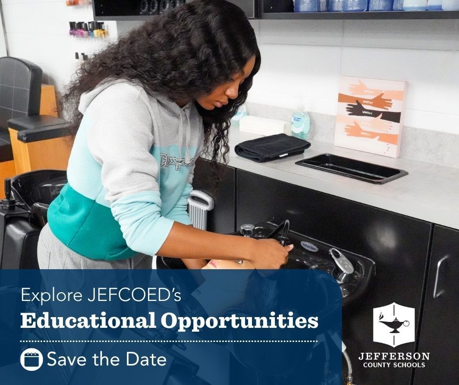 Female student washing hair on practice mannequin head in cosmetology class 