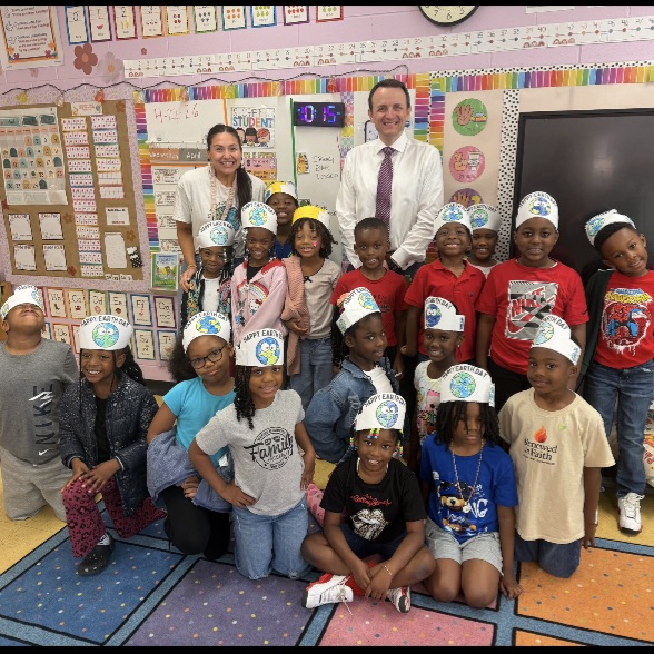 A picture of the weatherman Jonathan Hardison using the ViewSonic while reading a book about earth day to Ms. Gilreath's class.