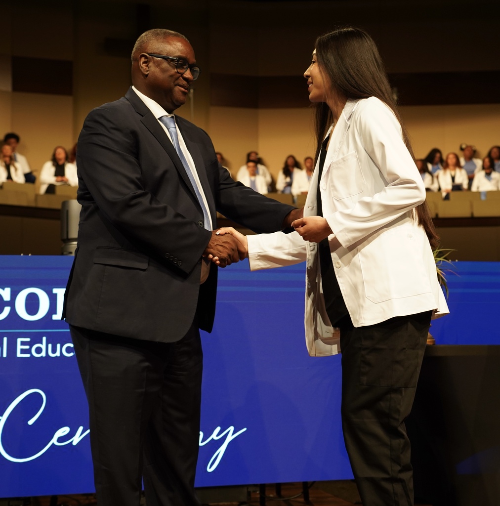A girl shakes Superintendent Dr. Walter Gonsoulin's hand during the JEFCOED White Coat Ceremony.