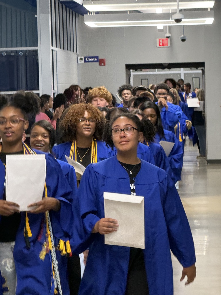 students walk the halls in their robes