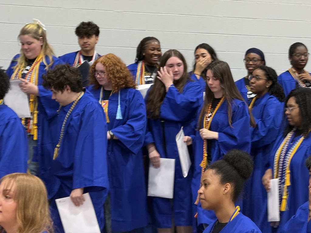 students crying and emotional after getting their robes